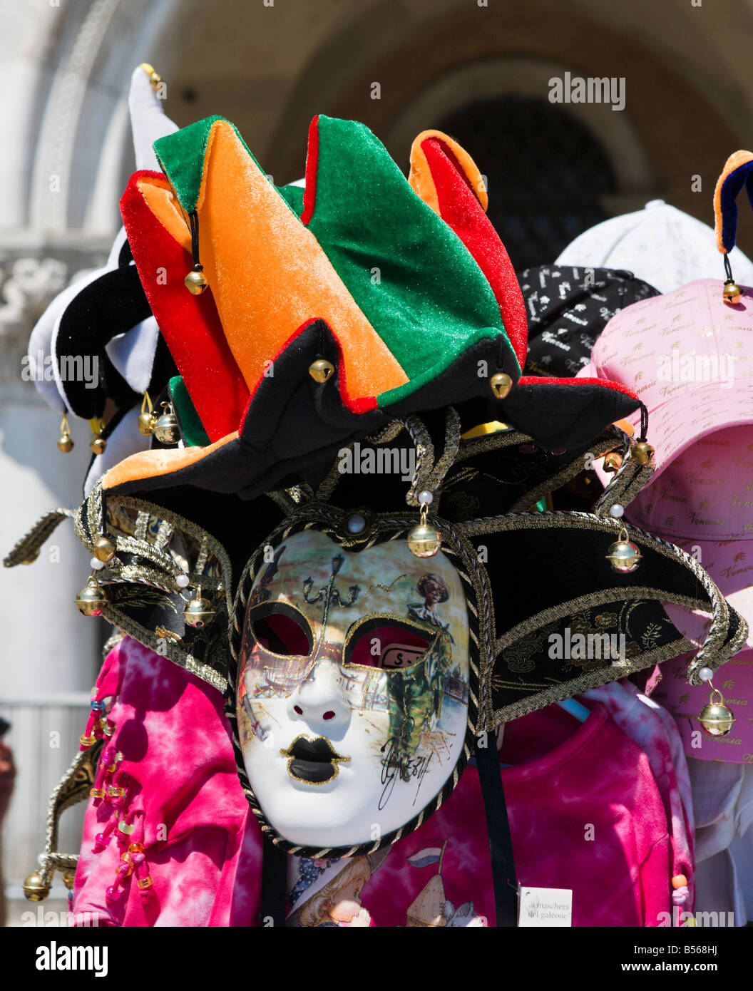 Market stall selling carnival masks and jester hats outside the Palazzo Ducale, the Molo, San Marco, Venice, Veneto, Italy Stock Photo