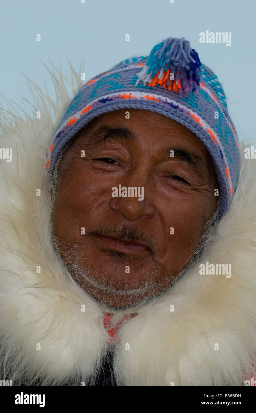 Inuit hunter Jake Awa of Pond Inlet wearing a traditional parka The hood is trimmed with polar bear fur Stock Photo