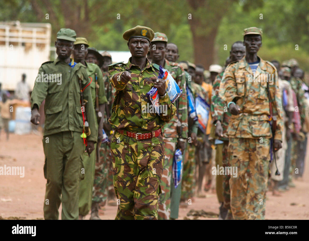 A contingent of the Sudan People's Liberation Army (SPLA) marches with mosquito nets in hand. Stock Photo