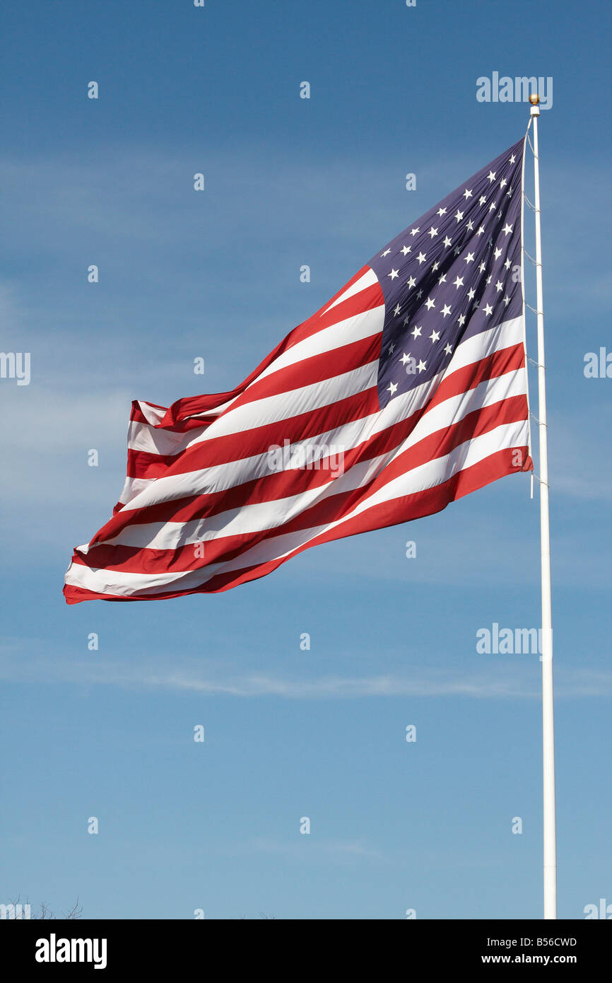 United States of America flag alone against a blue sky Stock Photo