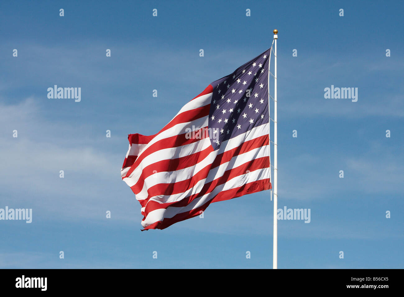 United States of America flag alone against a blue sky Stock Photo - Alamy