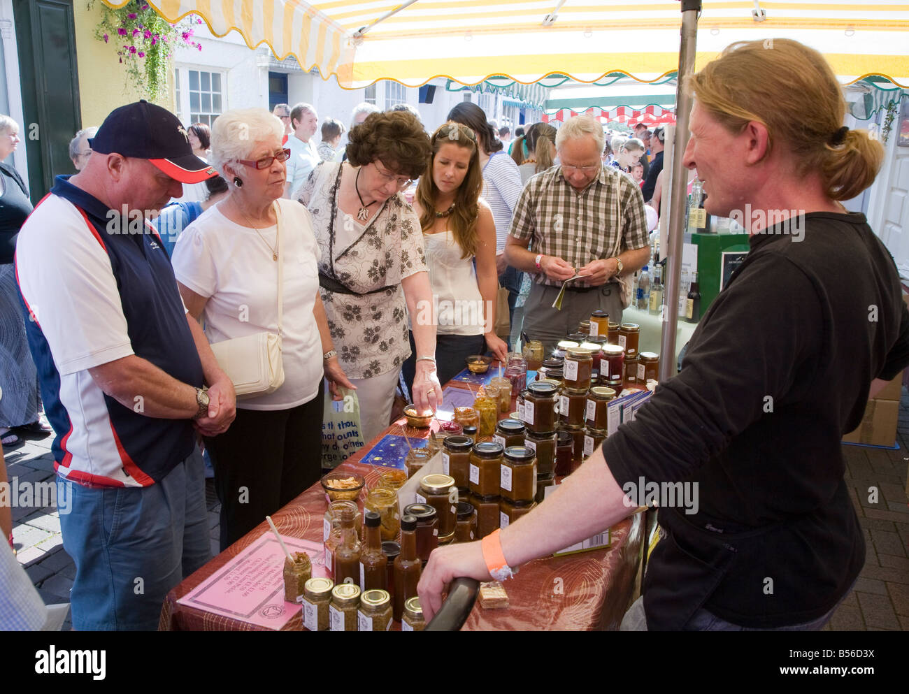 People buying chutney at local produce stall Abergavenny Food Festival Wales UK Stock Photo