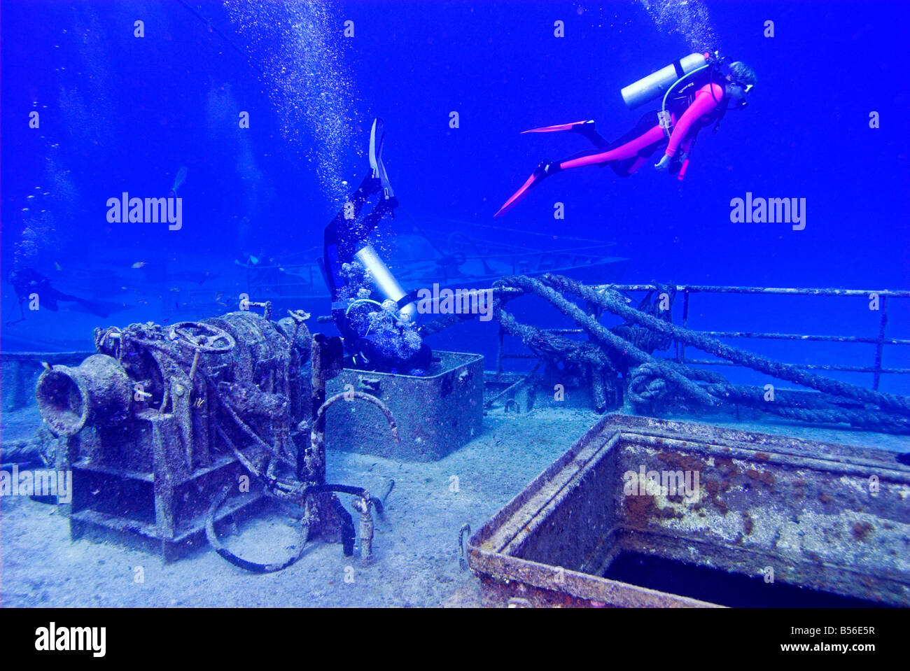 Divers exploring the decks of Twin Sisters shipwrecks Paradise Island Bahamas Stock Photo