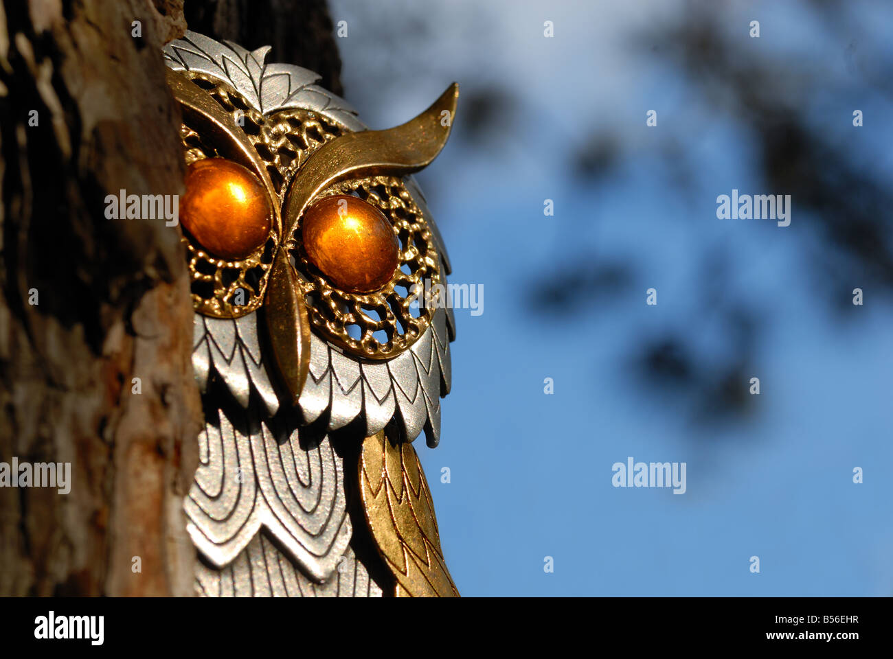 This owl with huge amber colored eyes is really a piece of costume jewelery Stock Photo