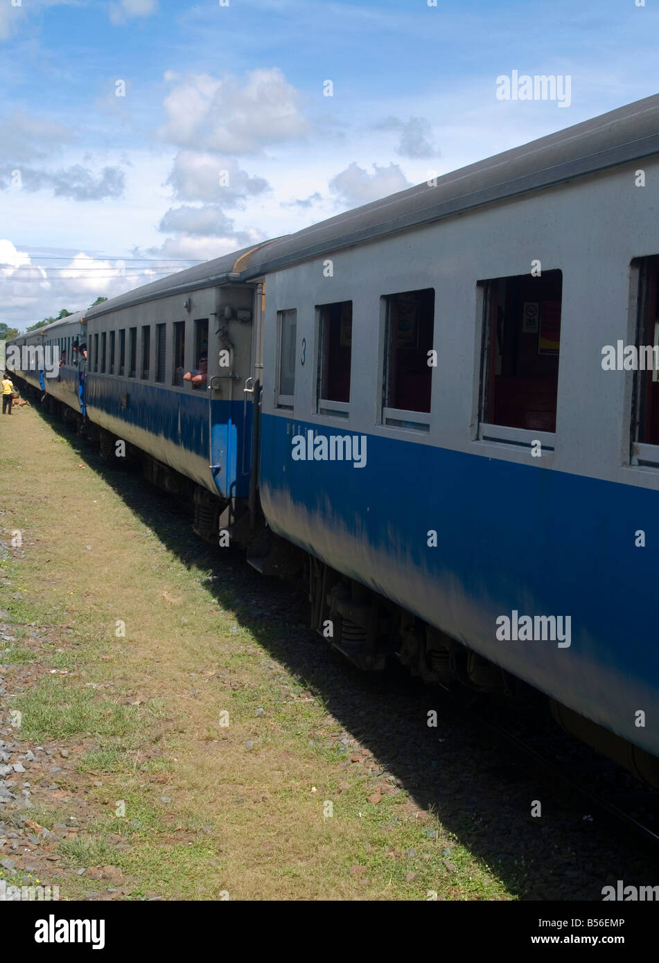 train traveling through the countryside in Thailand Stock Photo