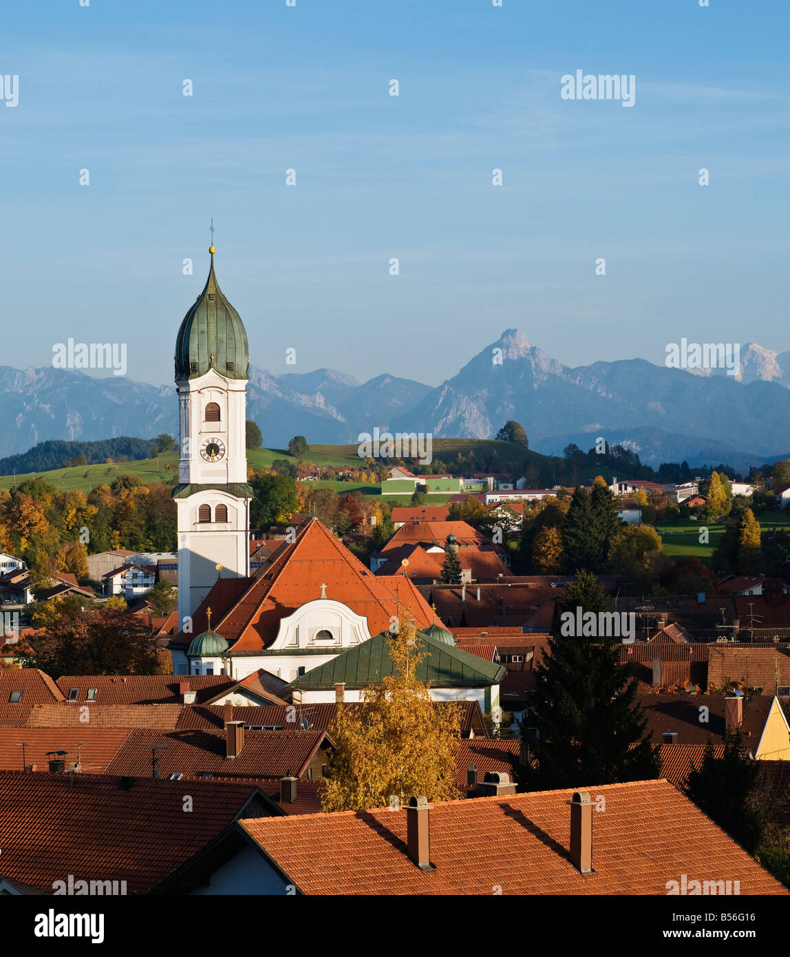 Tower of Saint Andreas Chuch and mountains of Allgaeu region, Nesselwang, Germany Stock Photo