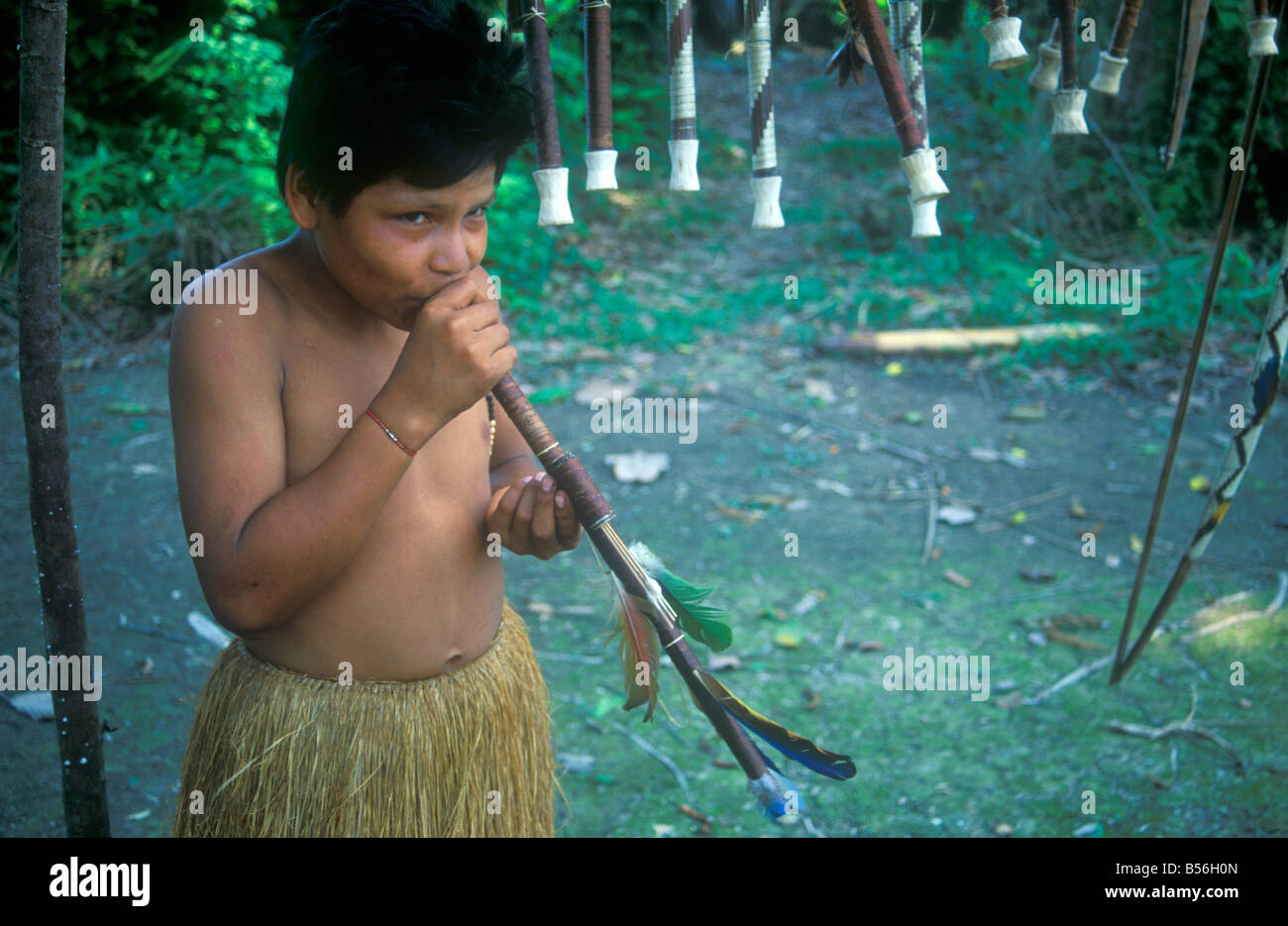 https://c8.alamy.com/comp/B56H0N/a-young-boy-presenting-a-blowtube-made-for-tourists-at-a-yagua-indian-B56H0N.jpg
