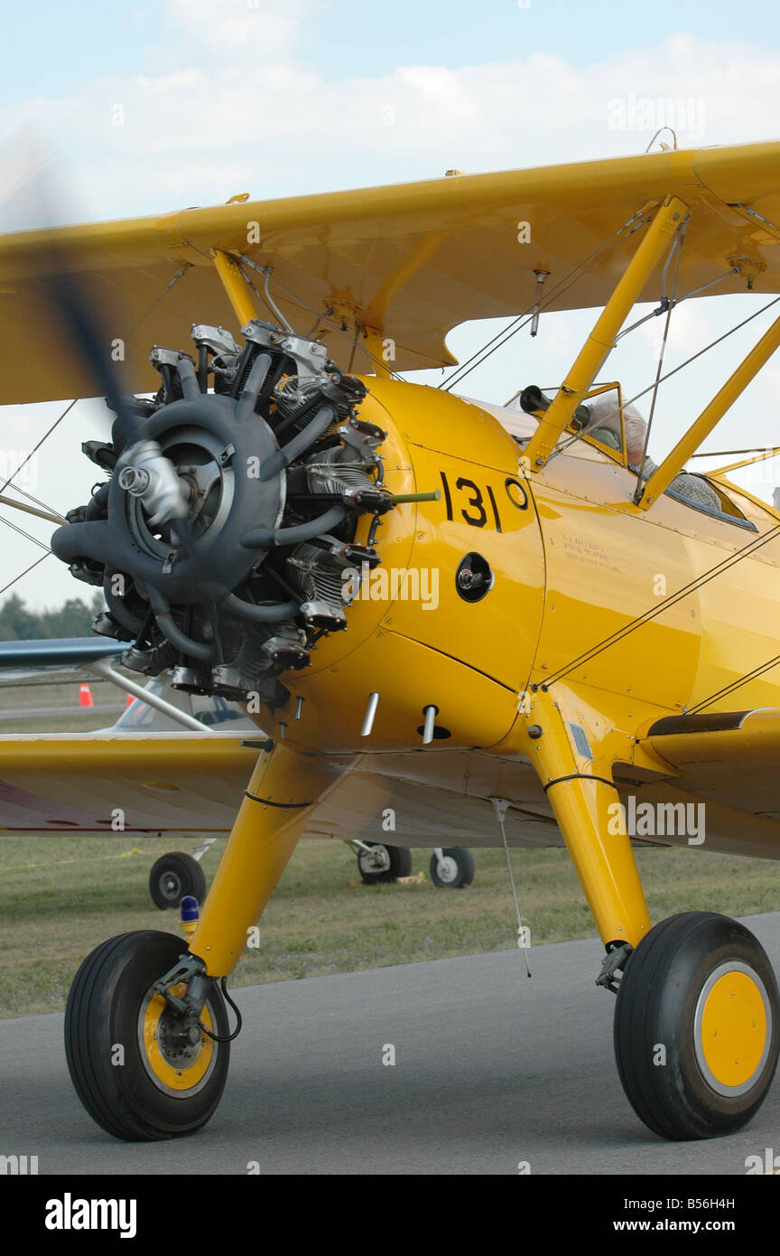 A yellow propellor driven small aircraft. Stock Photo