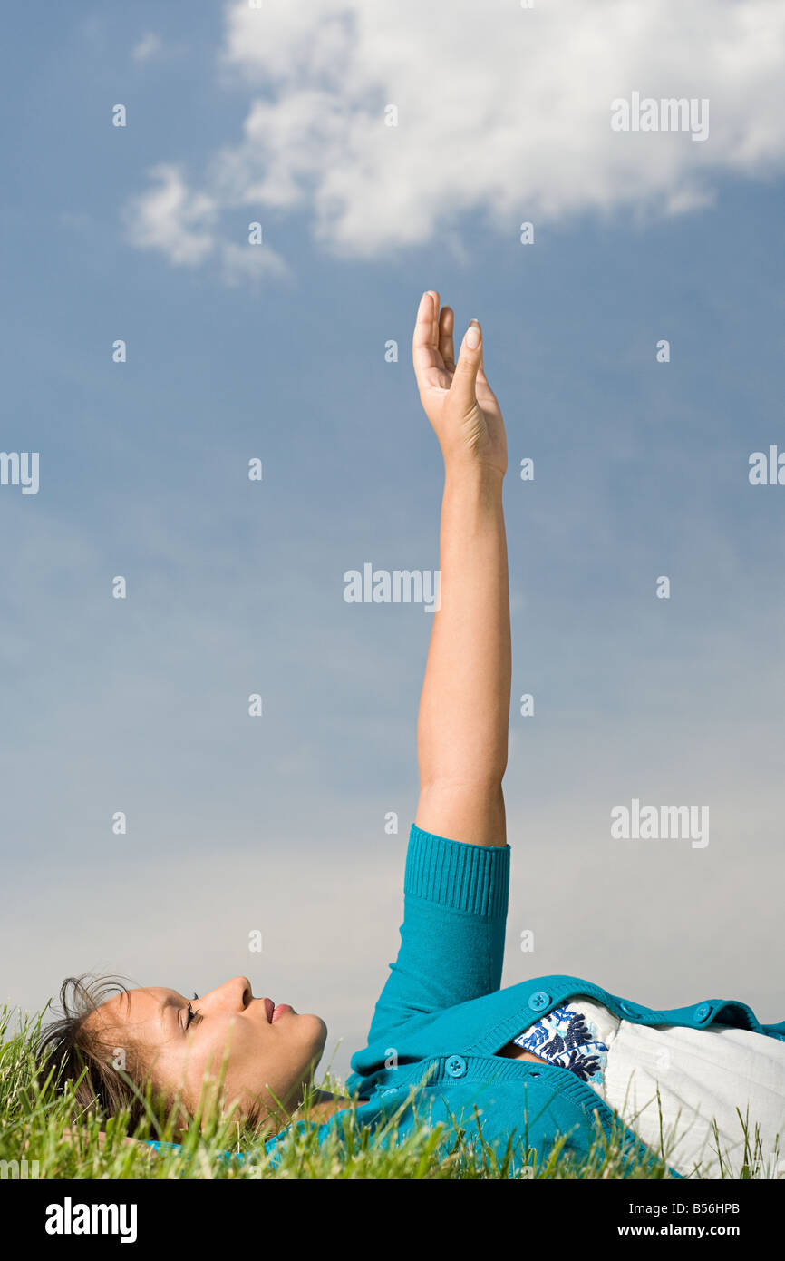 Woman lying down with arm raised Stock Photo Alamy