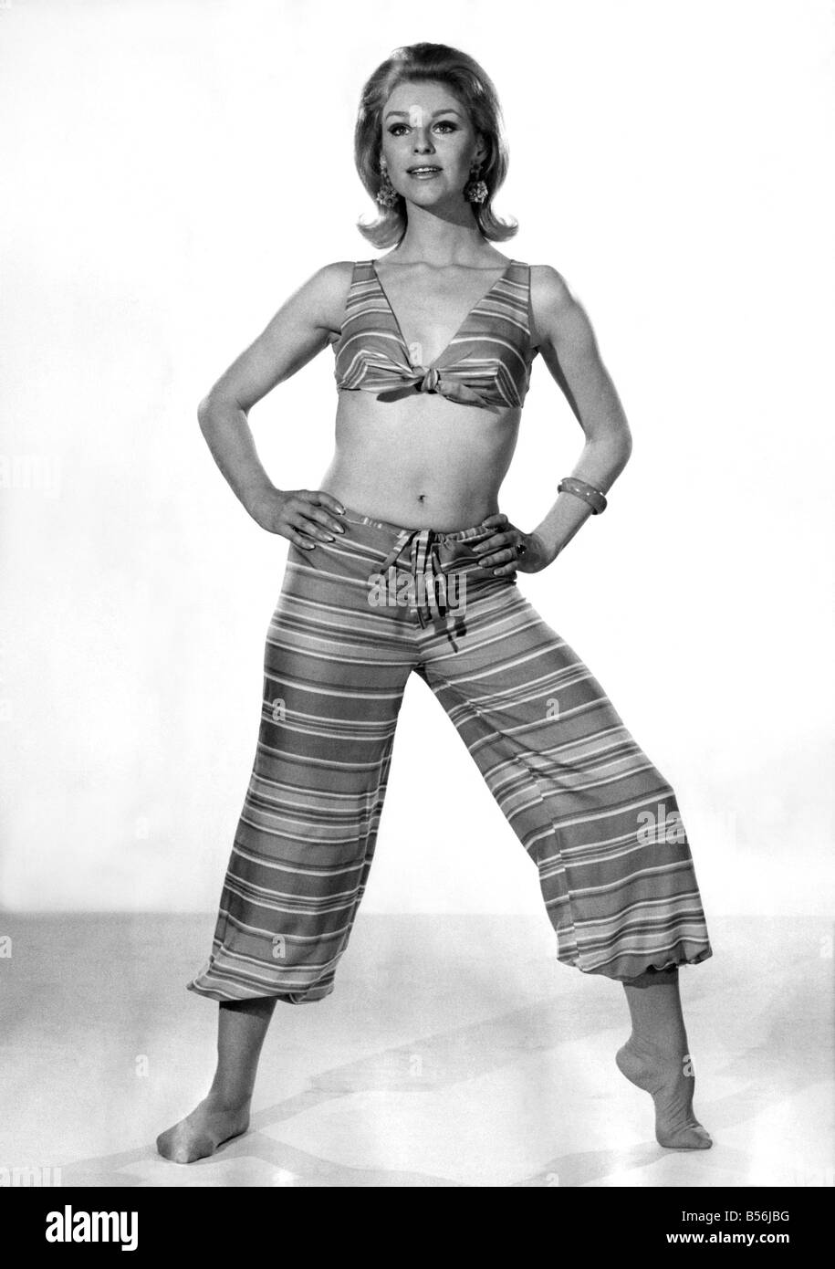 An exotic two-piece straight from the Arabian Nights. The harem pants are gathered at the ankle, and the plunge-front top ties in a knot. June 1968 P008406 Stock Photo