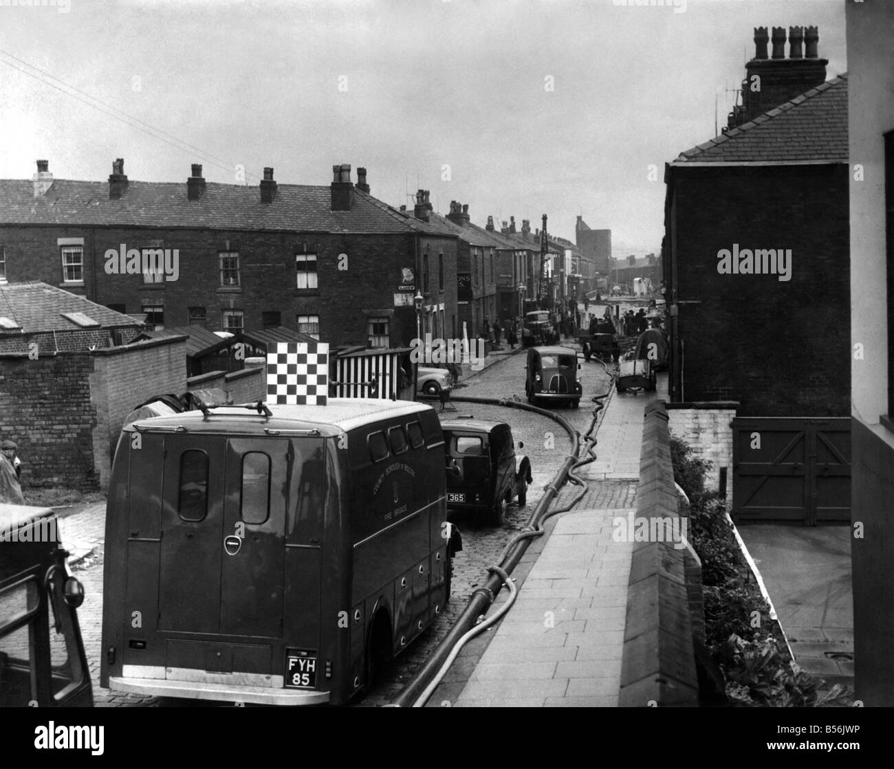 Farnworth landslide. Looking along Fylde Street, which is now a hive of activity as firemen, police, and maintenance workers bring their vehicles and equipment. September 1957 P009108 Stock Photo