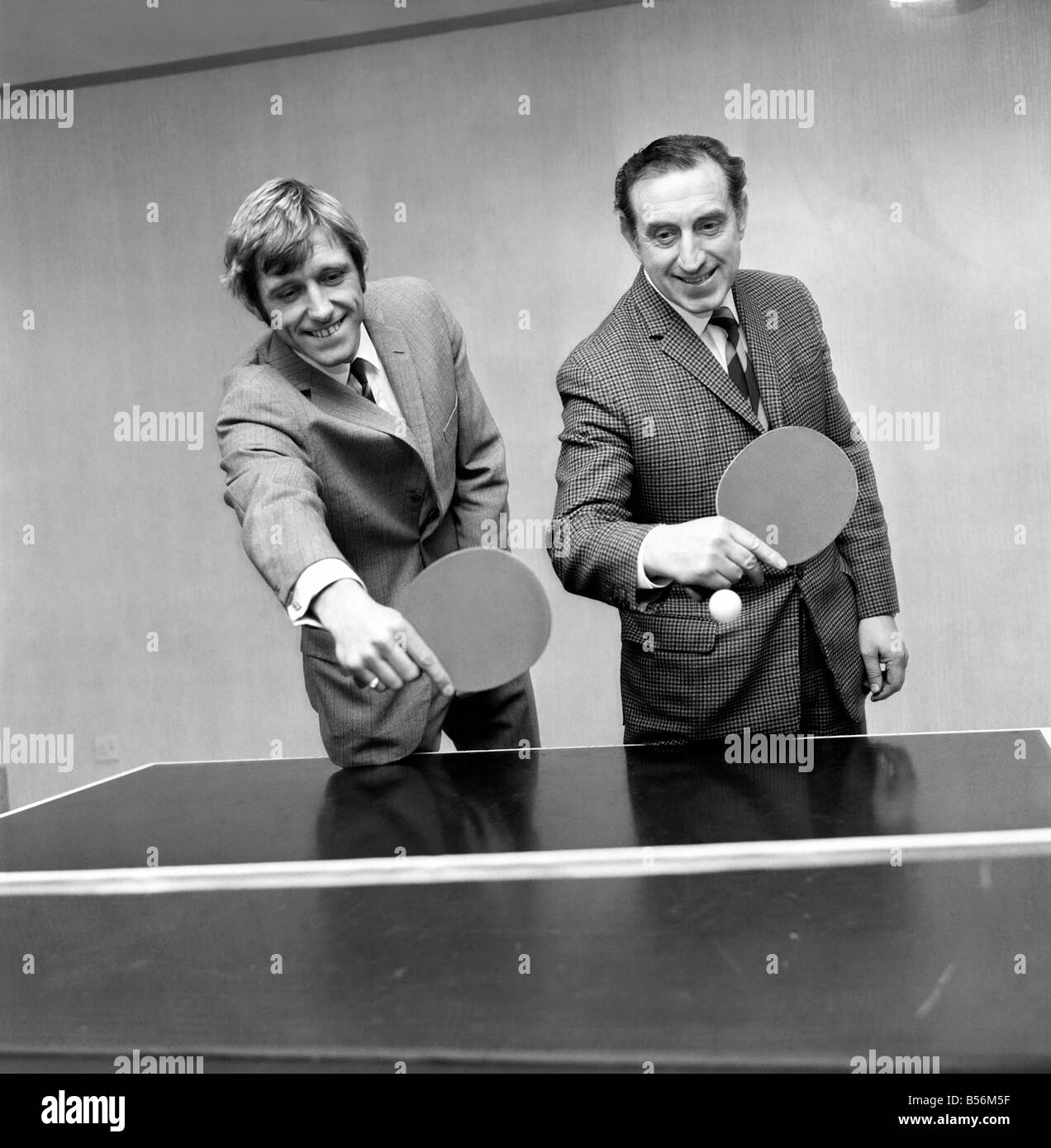 Keith Newton the Blackburn Rovers player signed for Everton yesterday. Keith Newton plays a shot when partnering his new boss Harry Catterick, manager of Everton, with a game of table tennis after signing. December 1969 ;Z12172 Stock Photo