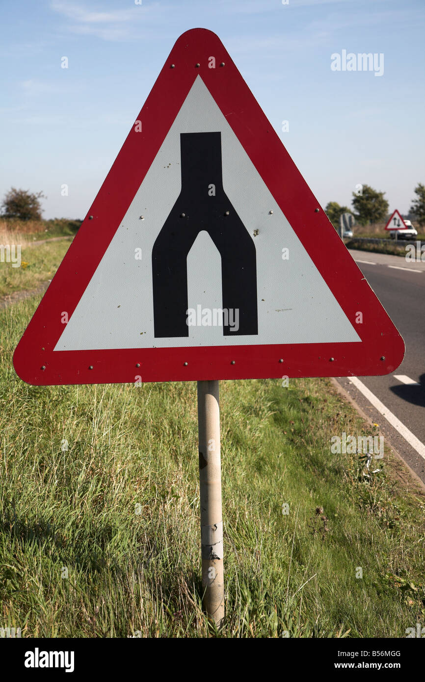 End of dual carriageway red triangular road sign Stock Photo - Alamy