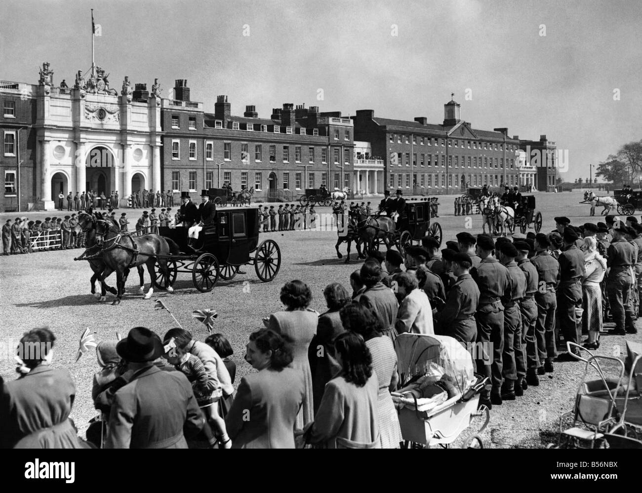 Woolwich: General view showing horses walking between ranks of cheering troops, to enable to them to get accustomed to the noise which they will have to contend with during the coronation procession. May 1953 P09586 Stock Photo