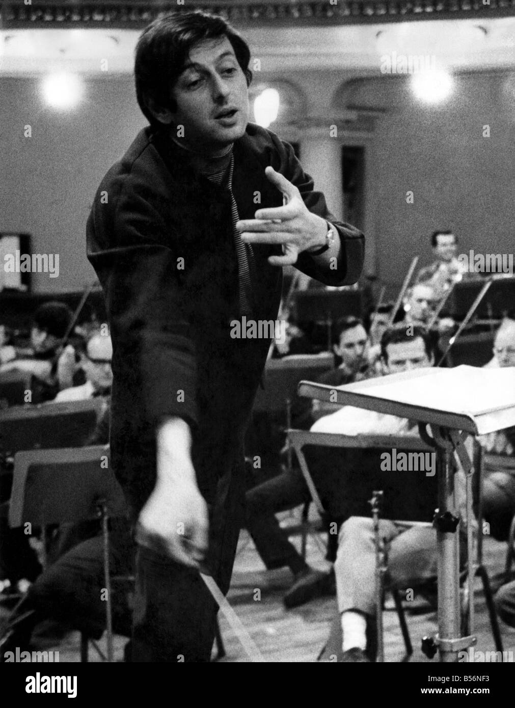 Pictures of conductor Andre Previn in action during a record session with the London Symphony Orchestra, at the Kingsway Hall. March 1969 P009800; Stock Photo
