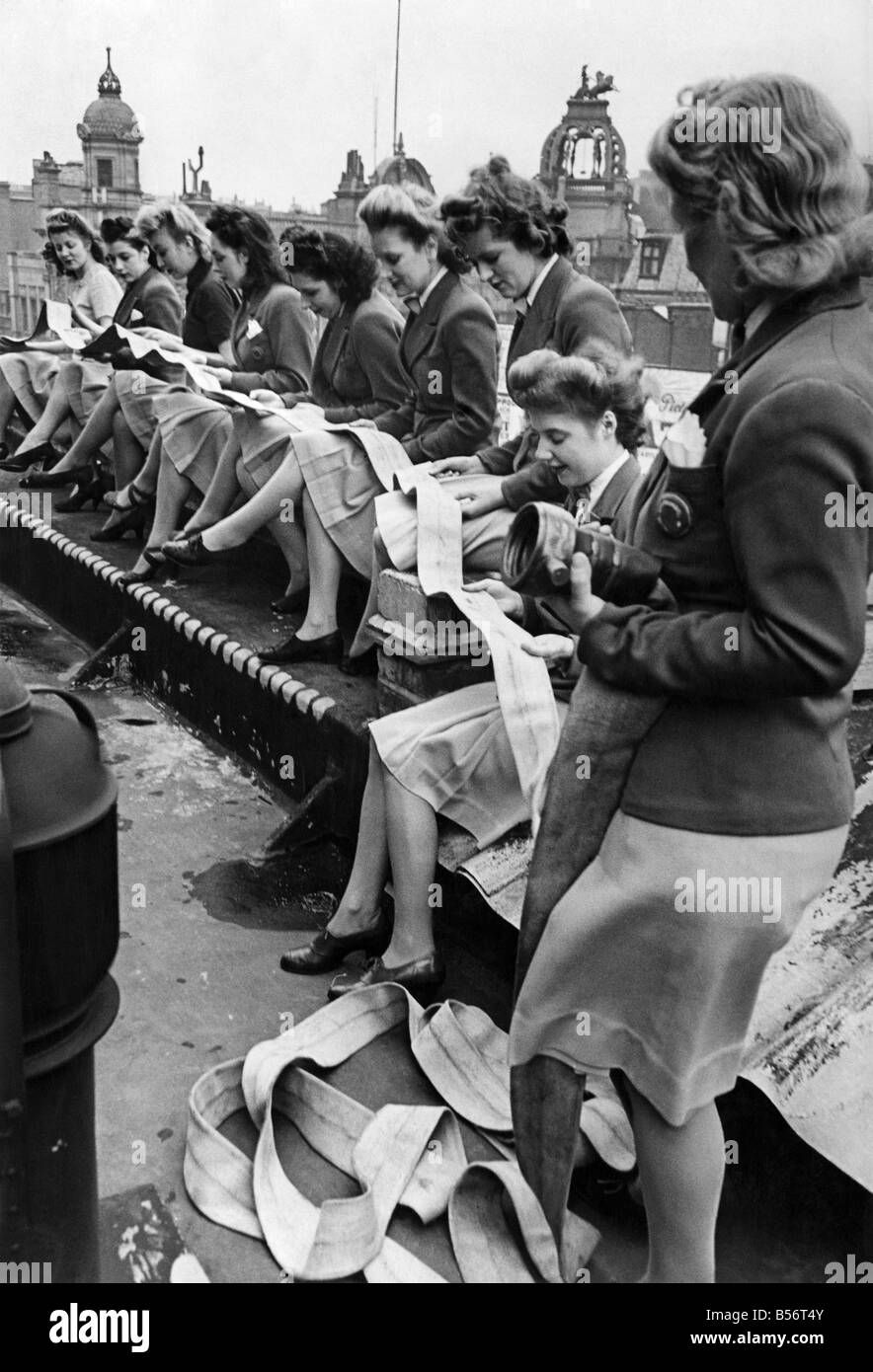 Odeon usherettes looking for ladders in a new kind of hose not the silk kind. They form a fire fighting squad at the cinema in Leicester Square and have had a lot of experience during the blitz. ;February 1943 ;P010290 Stock Photo
