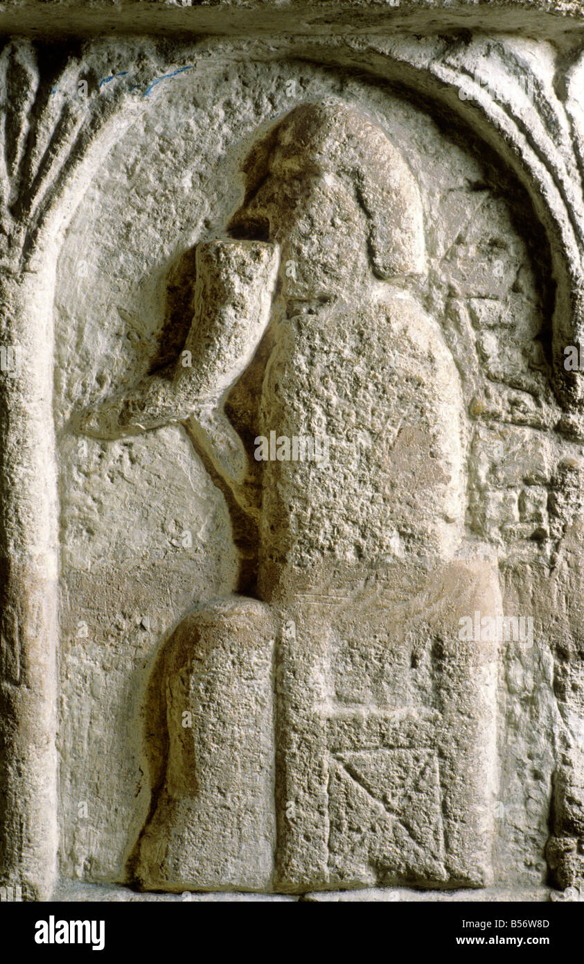 Burnham Deepdale Norman Font detail January Drinking from a horn vessel cup labour of the month Romanesque art 12th century Stock Photo