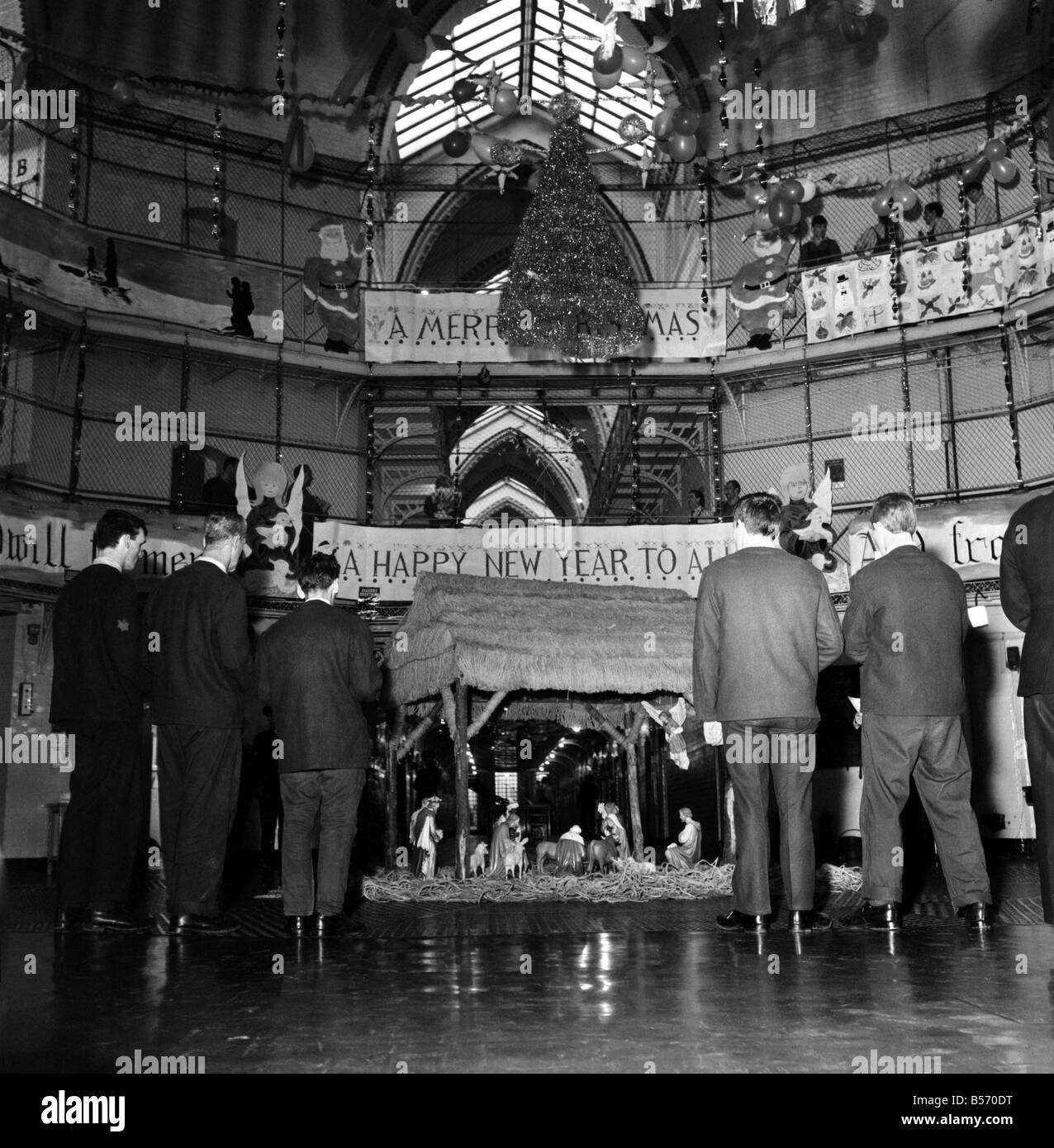 Instead of the customary Xmas tree in the centre of the prison wings of Strangeways Gaol, Manchester, there is to be a crib. A carol service will be held around the crib at which the prisoners will attend. Our picture shows, Prisoners at rehearsals and, decorating the prison and crib in the central hall. December 1969 Z12381-003 Stock Photo