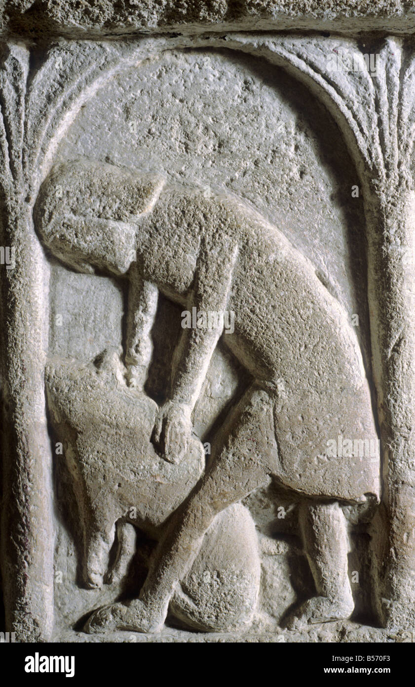 Burnham Deepdale Norfolk Norman stone Font detail Labour of the Month November Pig Killing 12th century carving Romanesque art Stock Photo