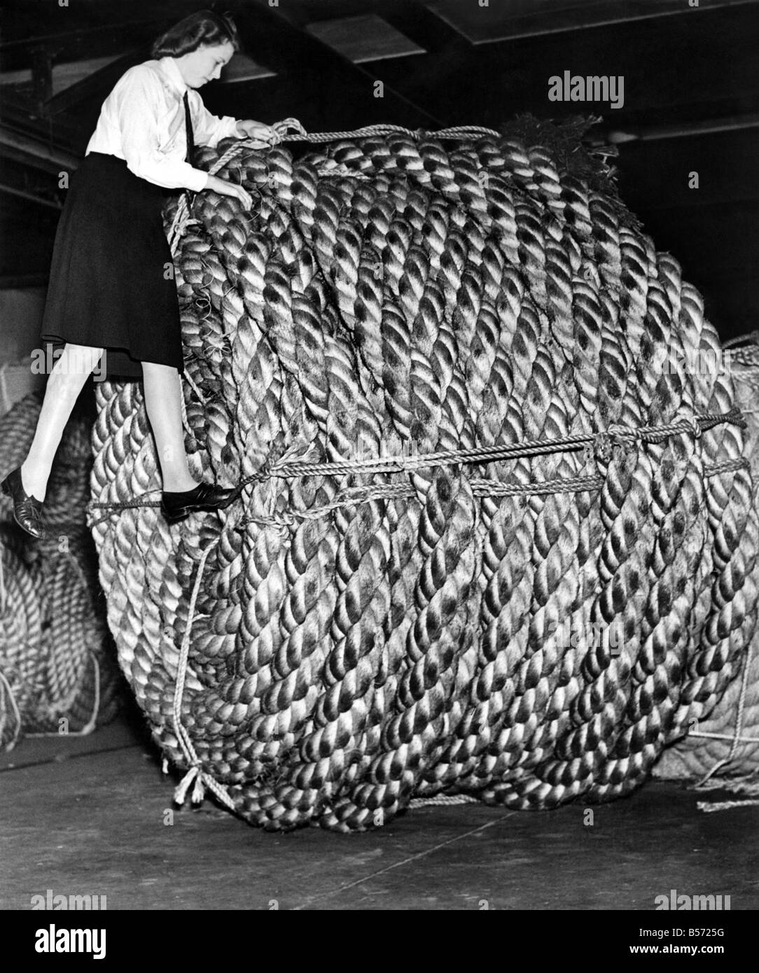 Rope making at a London factory. ;A huge coil of rope weighing three and a half tons and 720 feet in length and is 18 inches in Stock Photo