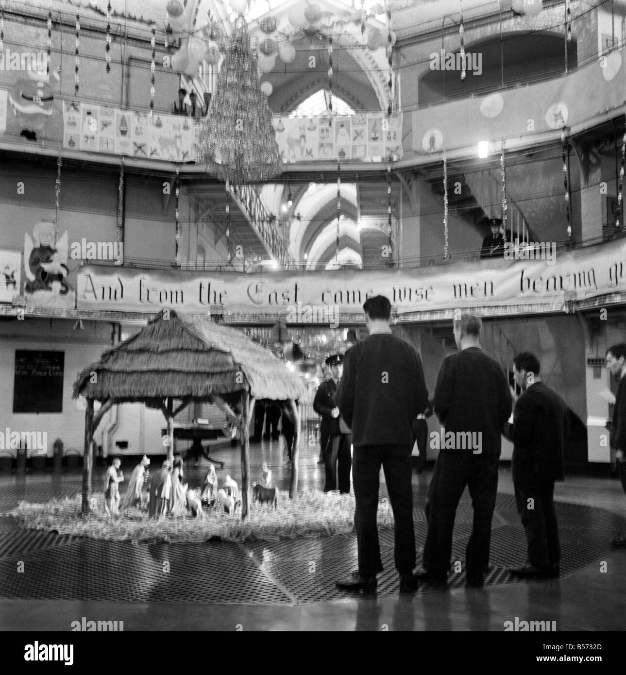 Instead of the customary Xmas tree in the centre of the prison wings of Strangeways Gaol, Manchester, there is to be a crib. A carol service will be held around the crib at which the prisoners will attend. Our picture shows, Prisoners at rehearsals and, decorating the prison and crib in the central hall. December 1969 Z12381-002 Stock Photo