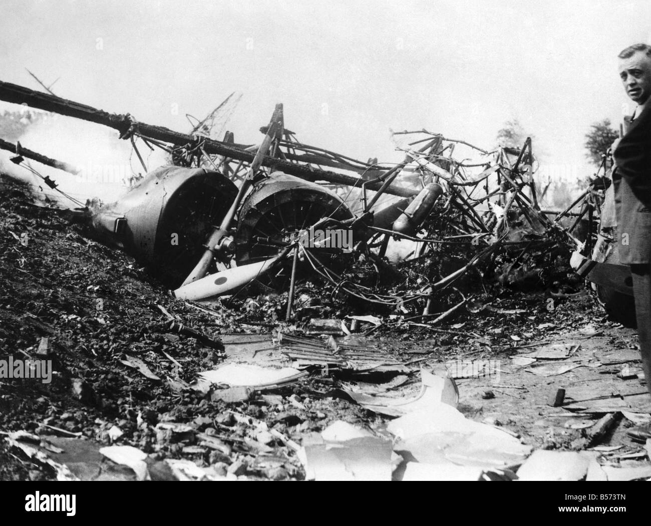 Dutch Air Liner Crash. Six people, two of them Englishmen, were killed and three seriously injured, when a Dutch air liner, carrying twenty persons, crashed and burst into flames at Schephol Aerodrome, Amsterdam. Photo Shows. The remains of the air liner still smouldering showing the engines. July 1935 P003922 Stock Photo
