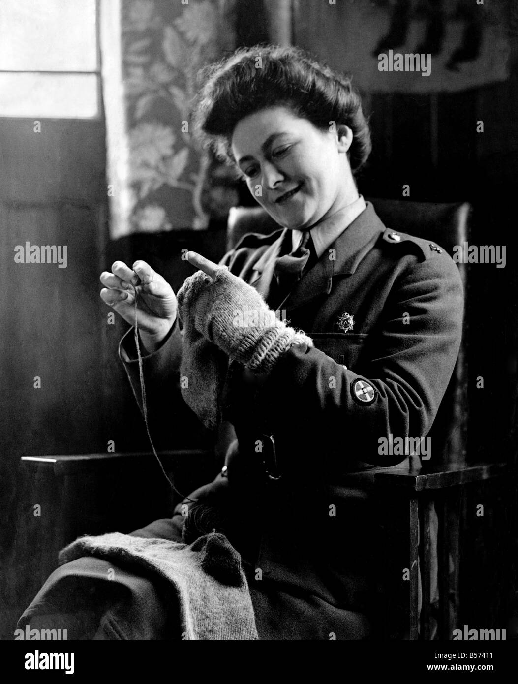 World War II Women: Camp Romance. Private Dorothy Brownlow darns her husband socks. March 1944 P010167 Stock Photo