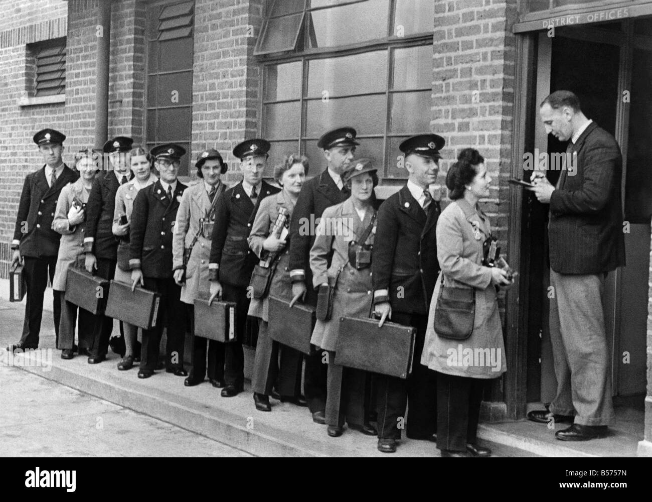 Husband and wife bus crews check in at the depot at North Fleet. From right to left: Mr. and Mrs. William Reader, Mr. and Mrs. Walter Coole, Mr. and Mrs. Fred Annal, Mr. and Mrs. Ernest Fifield, Mr. and Mrs. James Nolan, Mr. and Mrs. John Cox. May 1944 P010126 Stock Photo