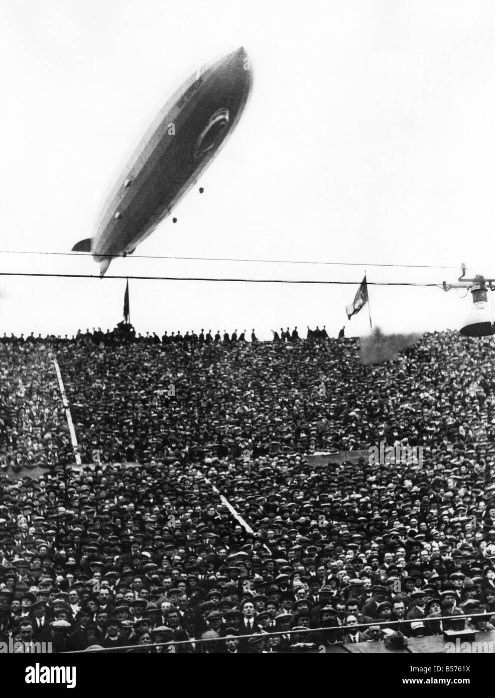 The Graf Zeppelin passing low over Wembley Stadium during the F.A. Cup Final in which Arsenal beat Huddersfield. The airship was booed by some of the crowd who thought it might distract the players. P004028;(OP.726-E) Stock Photo