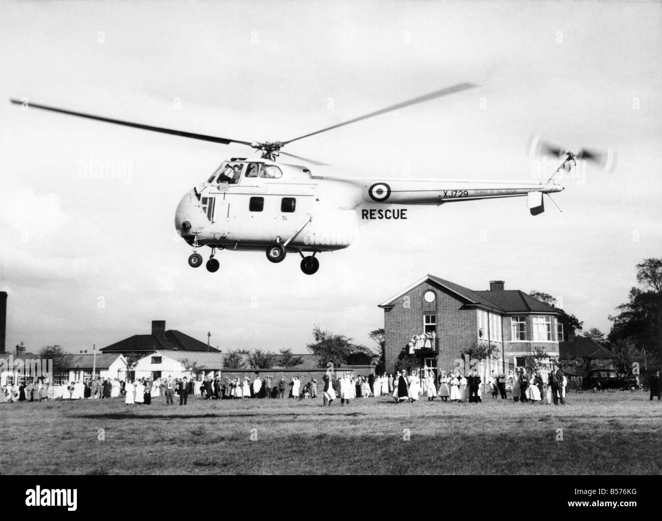 With a doctor and nurse at his side, a boy is being taken by this R.A.F. helicopter (1-10-57) to a hospital where he was rushed Stock Photo