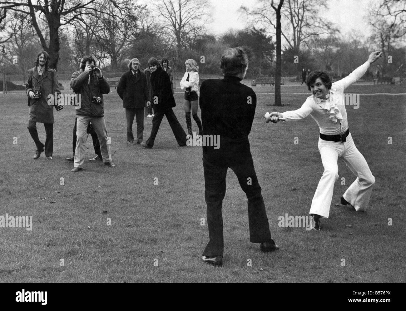 Actor-singer Jess Conrad challenged Actor Larry Taylor to a duel in Regents Park because of a dispute concerning ownership of car number Plate JC 21. Jess Conrad's face was insured for £20,000 by Lloyds. After the duel had been 'fought' for a few minutes near the open air theatre in Regents Park a Parks Police Cyclist arrived on the scene and told them that dueling was not aloud and they would have to stop. Jess Conrad's second was Andrew Ray. Larry Taylor's second was Rocky Taylor. The Judge was model Susan Louise 19 Stock Photo