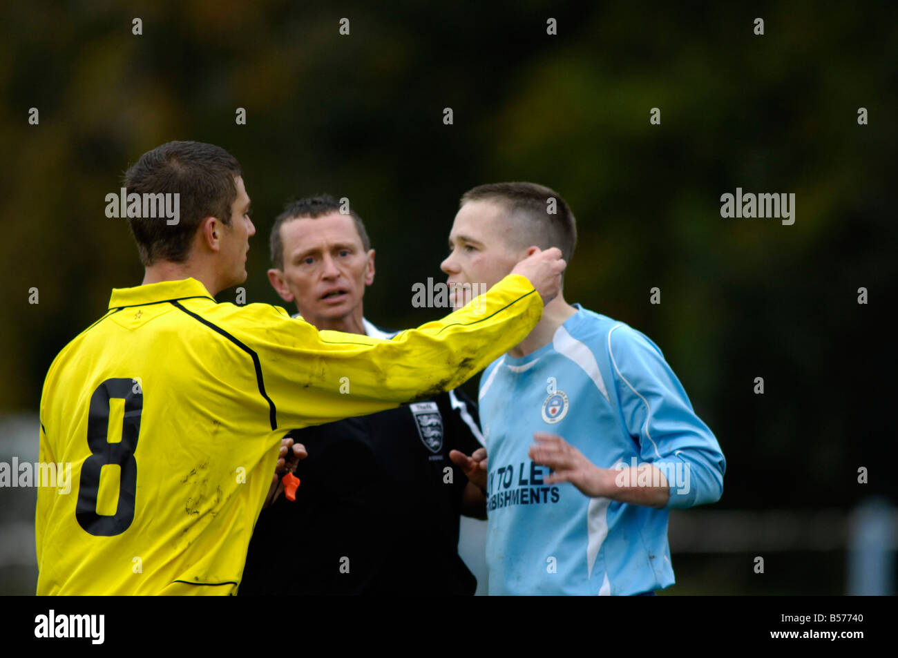 football player grabs the ear of an opponent Stock Photo