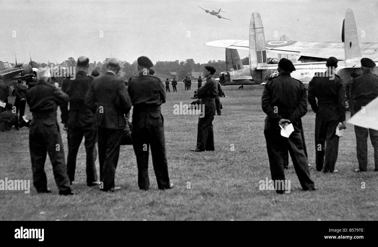 Hundreds of Men and women, members of the Royal Observer Corps were entertained at North Weald Aerodrome today with an air display. The occasion was also the stand down parade of the RoC but not the disbanding of the Corps. There will still be a skeleton membership, in feet the RoC will still exist. Men and women from all over Britain attended the ceremony. Photo shows. This is a new one on them. The Meteor Jet plane flies over the RoC Ceremony. Hardly and of the members of the Corps have seen this aircraft before. June 1945 P004824 Stock Photo