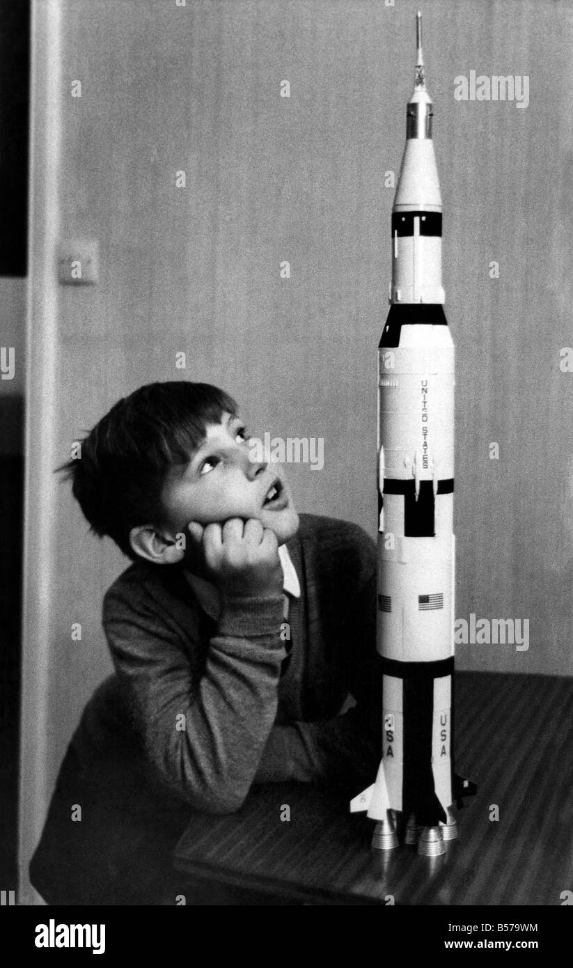 Toys-Space Rockets: Paul Ward of Belgravia, studies a model of the Apollo 12 rocket. November 1969 P004887 Stock Photo