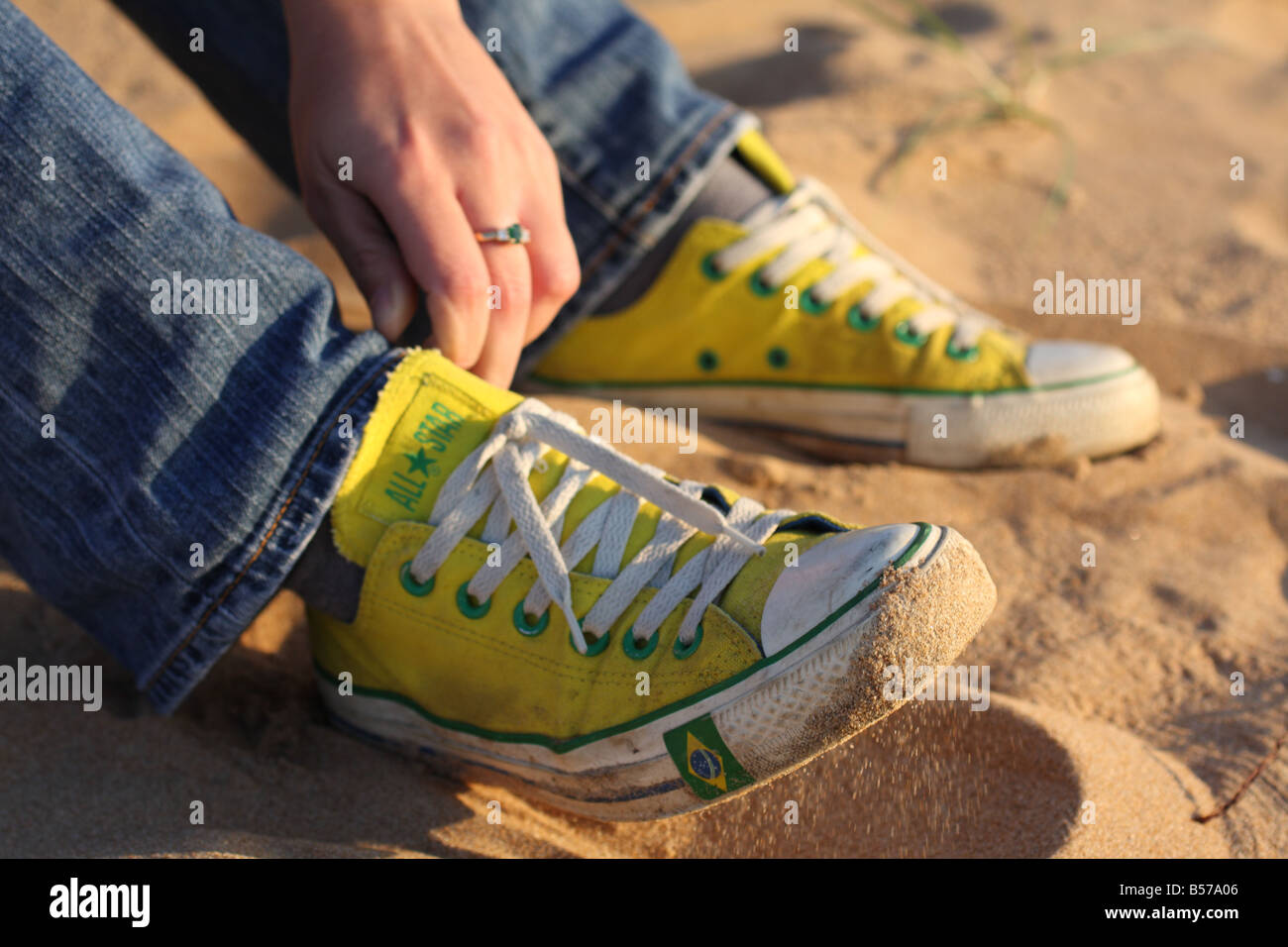 sneakers in the sand Stock Photo - Alamy
