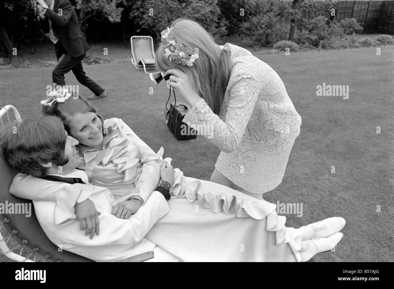 Mike McCartney's Wedding. Jane Asher takes a photograph of the bride and groom Mike McGear and Angela Fishwick. June 1968 Stock Photo