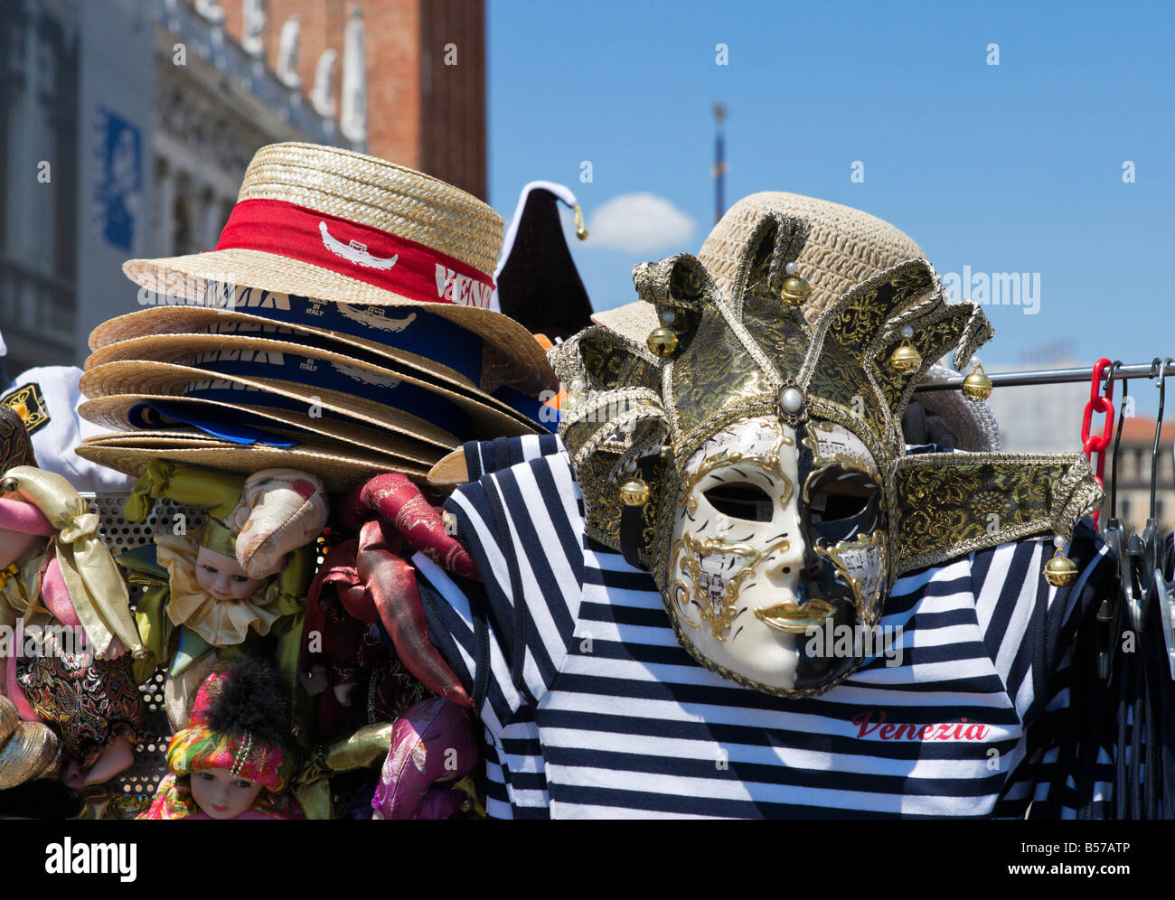 Market stall selling Venezia straw hats, shirts and carnival masks, Piazzeta, San Marco, Venice, Veneto, Italy Stock Photo