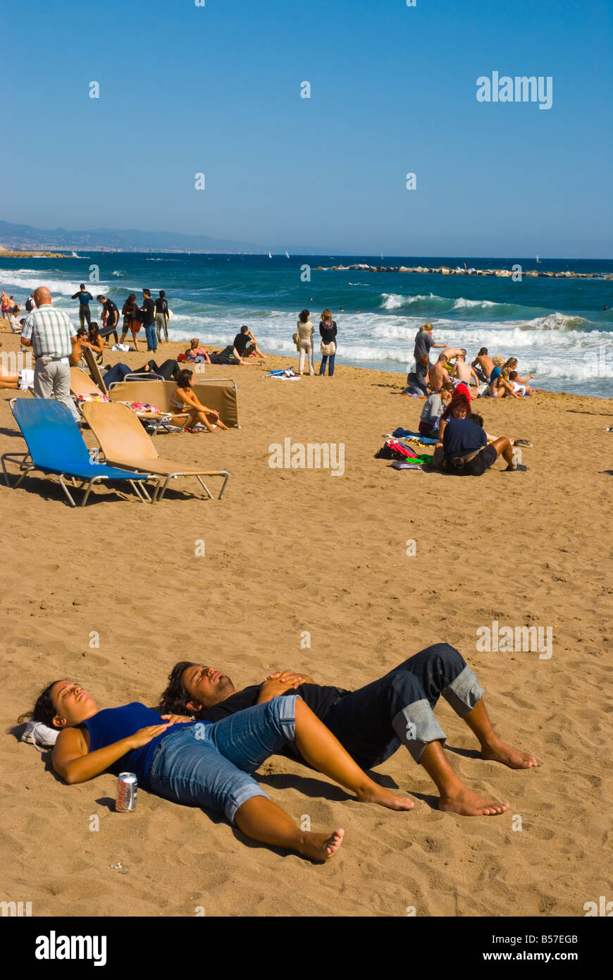 People relaxing at Platja de la Barceloneta beach in Barcelona Spain Europe Stock Photo