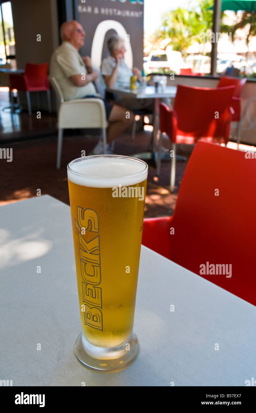 Glass of 500 ml of draft beer with no foam over a wooden table on a sunny  day Stock Photo - Alamy