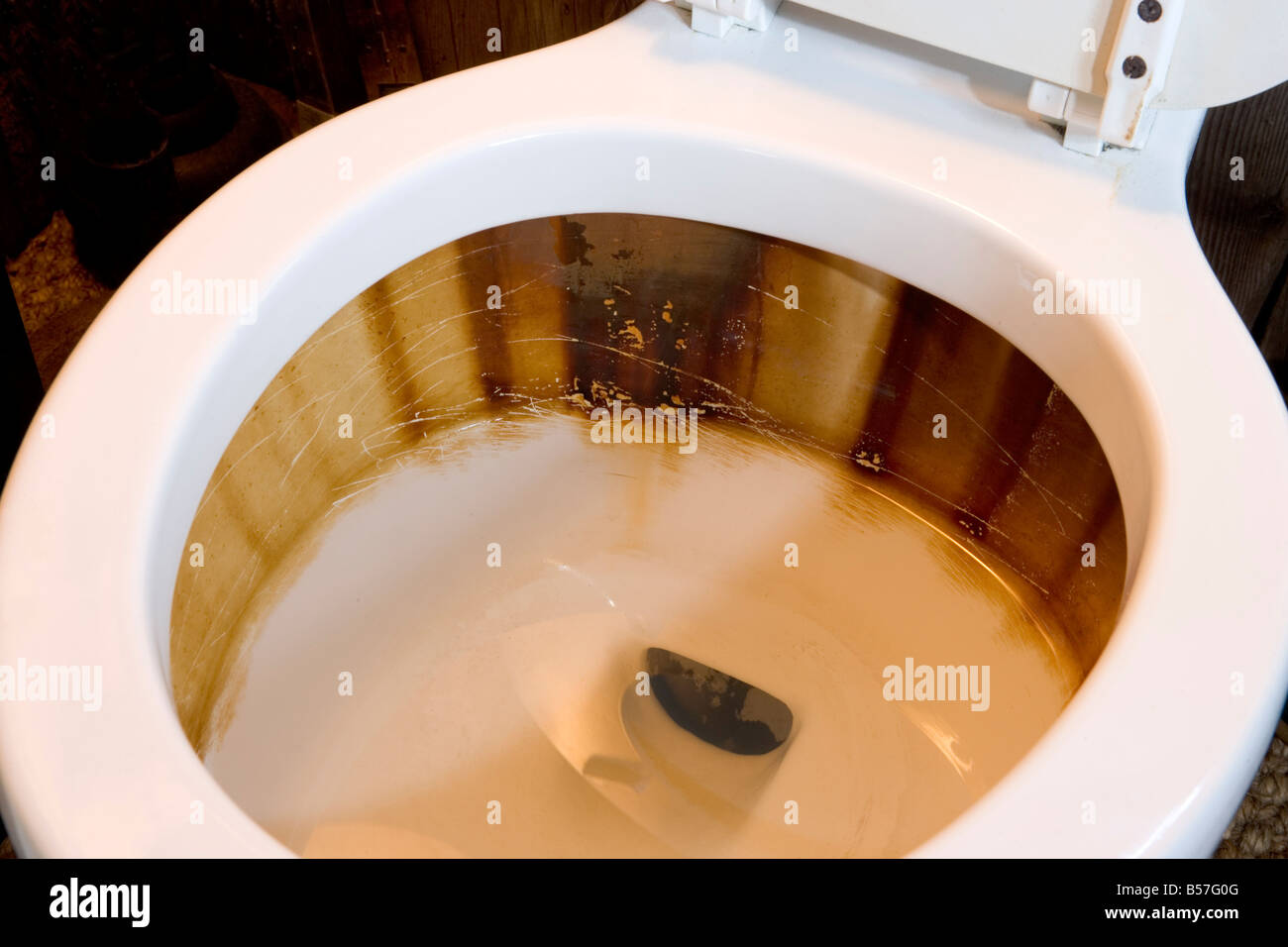 Water with high iron content leaves rust stains behind in places like toilet bowls and tanks This one is an extreme example Stock Photo - Alamy