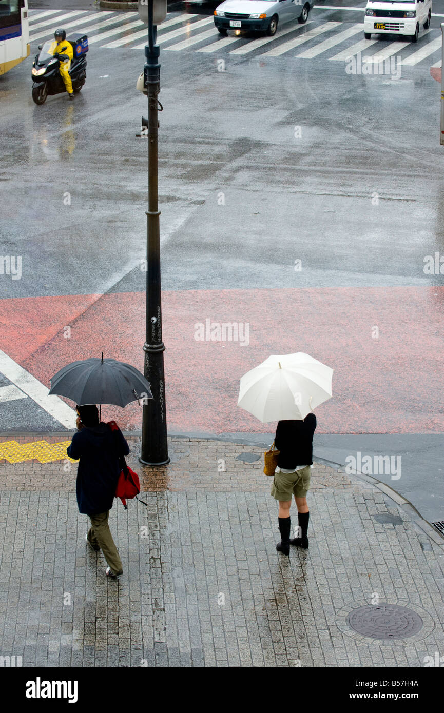 Ladies with umbrellas at the main crossing in The Shibuya district of ...