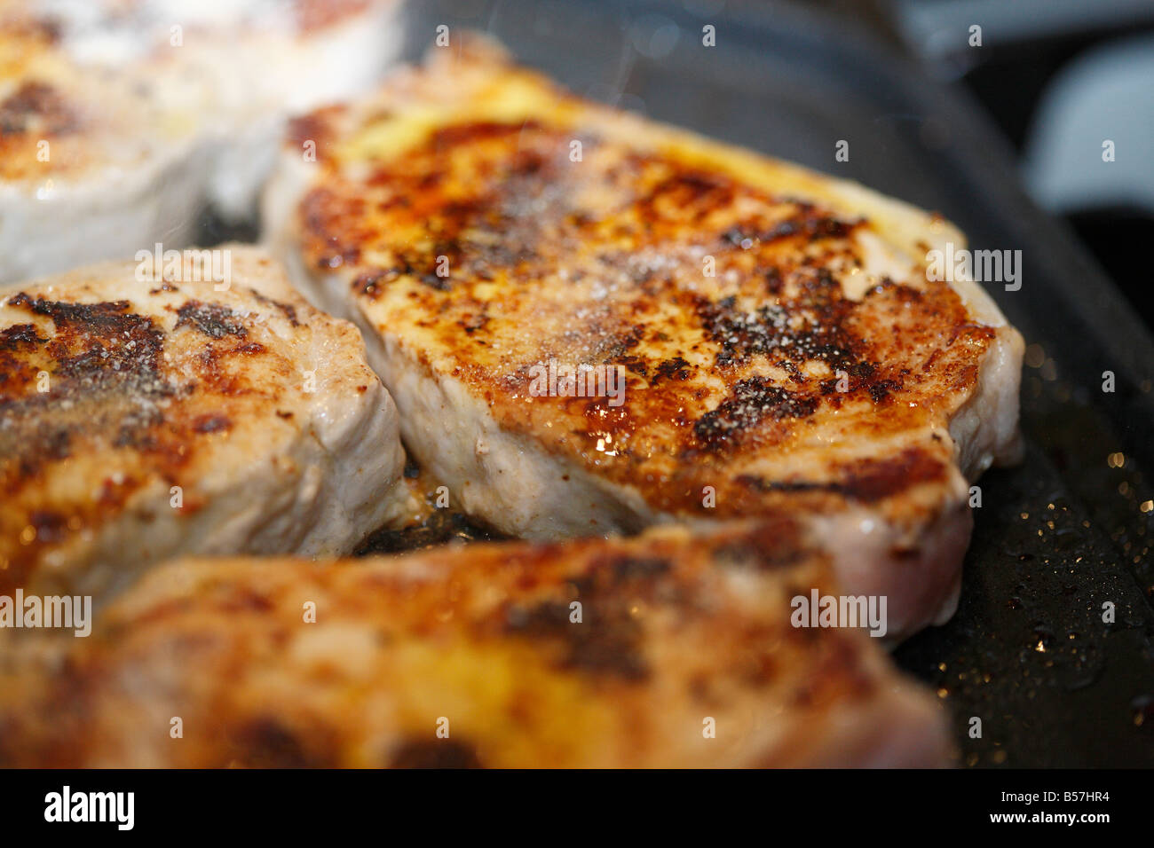 Pork Tenderloin steaks, being grilled on a hotplate. Stock Photo