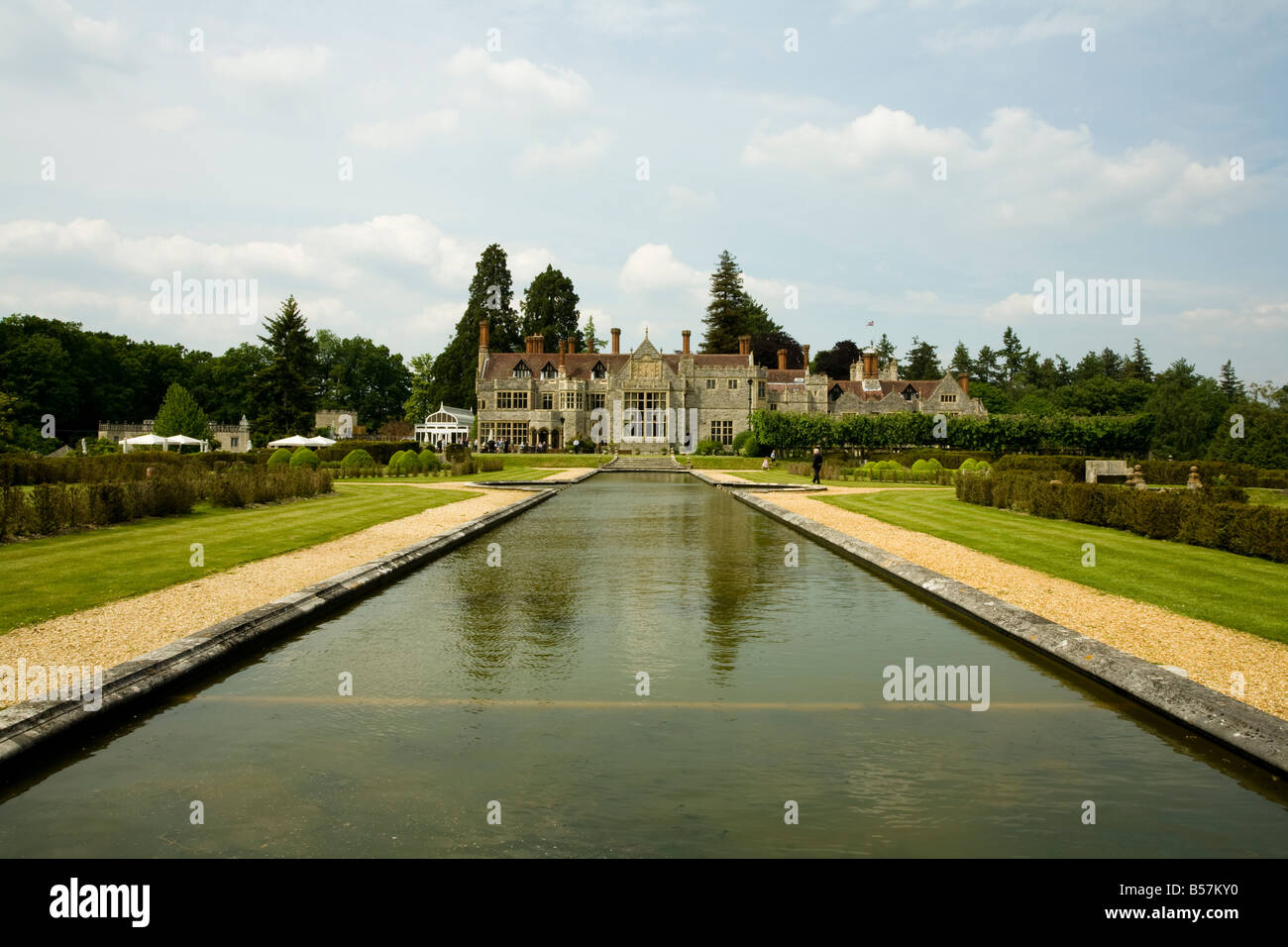 A man-made lake and water feature behind a original English Tudor country house. Stock Photo