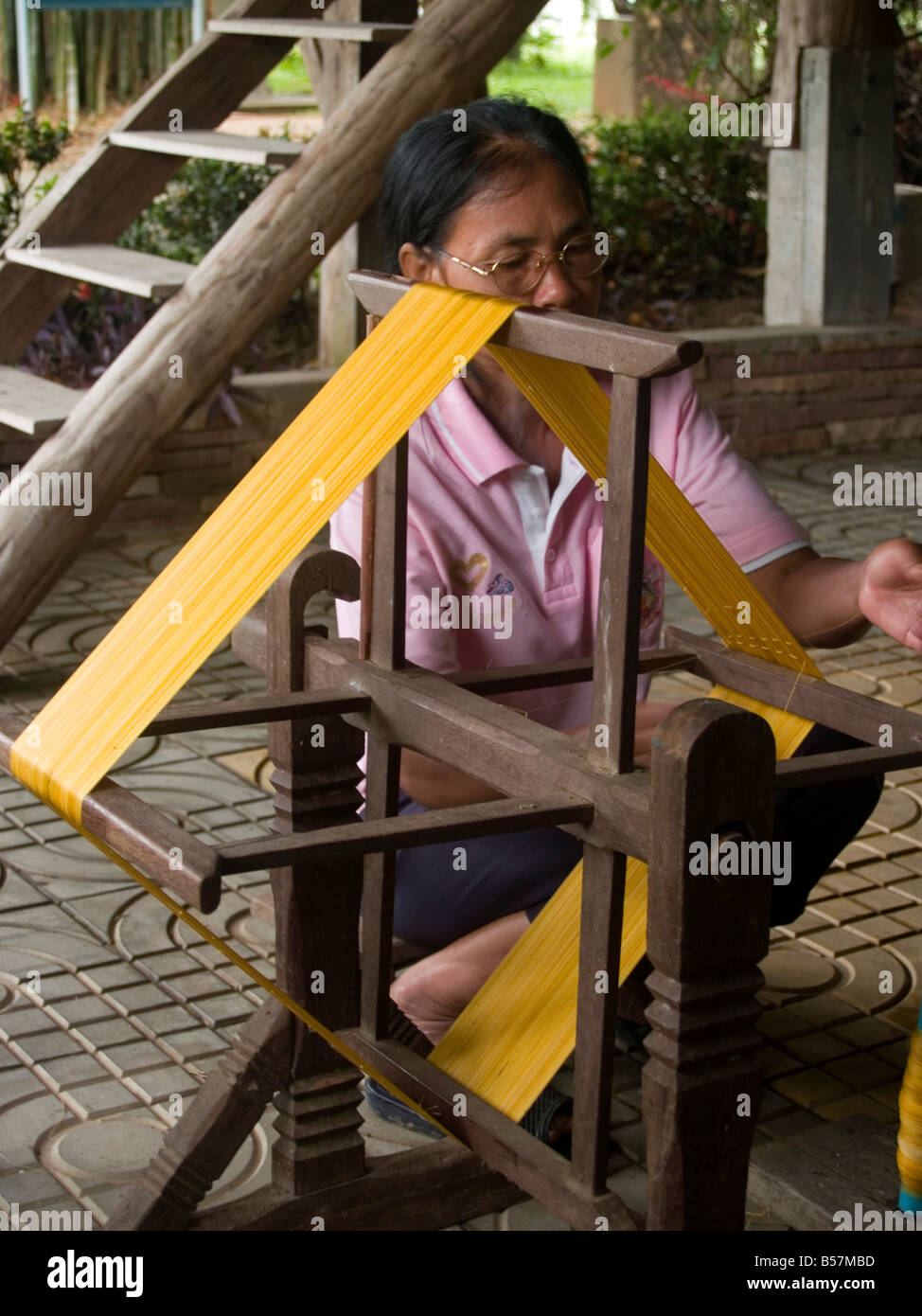 spinning silk thread at the Queen Sirikit Sericulture Center in Surin Thailand Stock Photo
