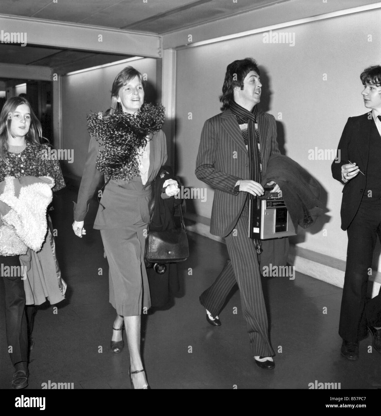 Pop star Paul McCartney and family. Carrying a portable radio, ex-Beatle Paul McCartney leaves Heathrow Airport today for a New Stock Photo