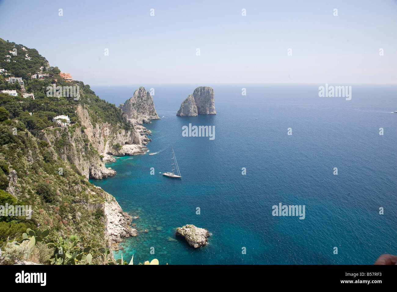 The coast line of the island of Capri, with the famous Faraglioni rocks ...
