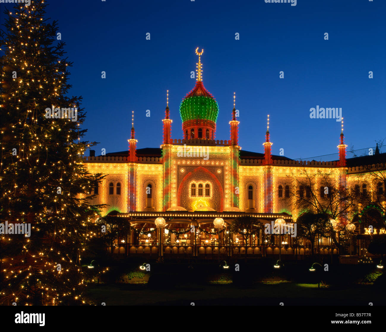 Illuminated Christmas tree and the Pavilion at dusk Tivoli Gardens Copenhagen Denmark Scandinavia Europe Stock Photo