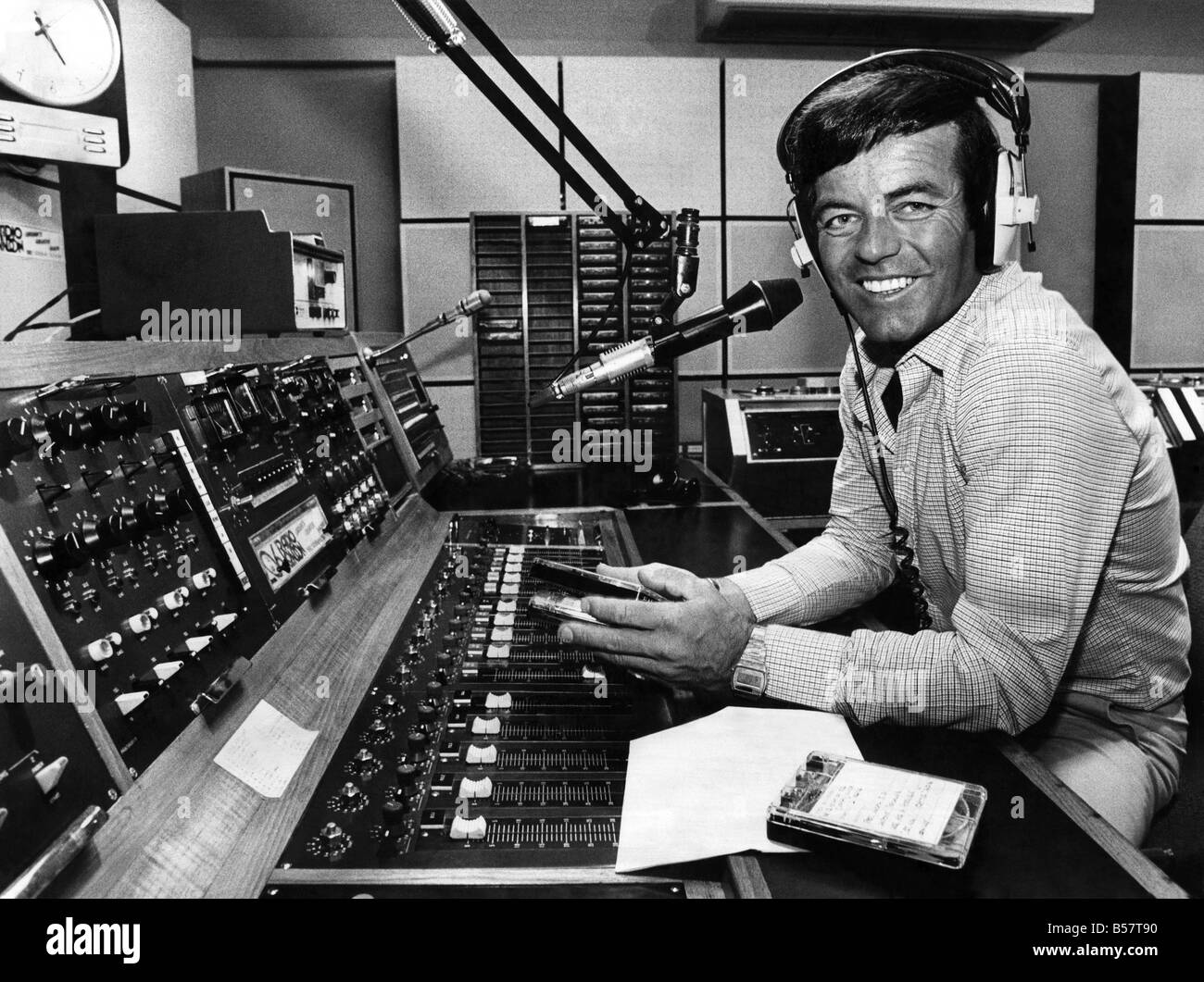 Radio One disc jockey Tony Blackburn behind the record decks spinning the discs for the millions listeners. September 1980 Stock Photo