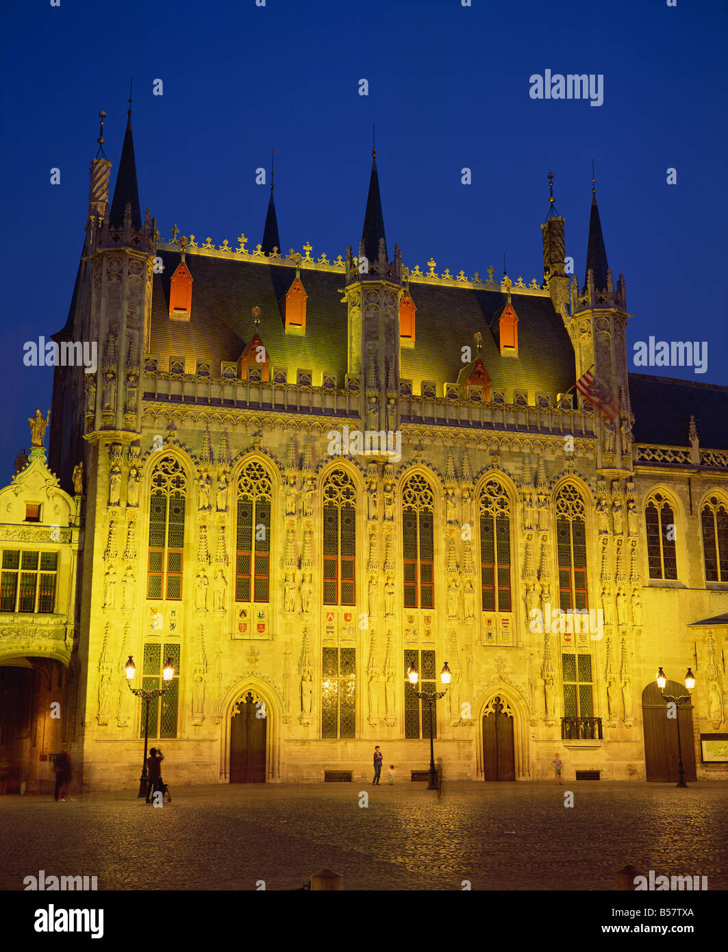 The illuminated facade of the Town Hall in Burg Square in Bruges at night Belgium R Rainford Stock Photo