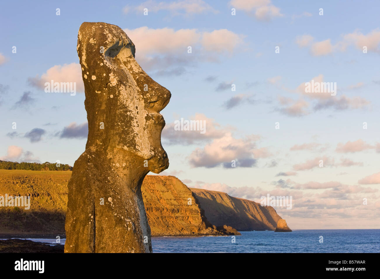 Lone monolithic giant stone Moai statue looking out to sea at Tongariki, Easter Island, Chile, South America Stock Photo